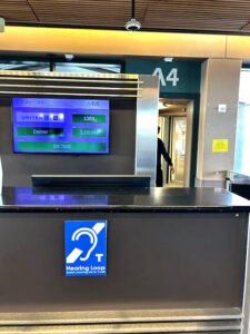 Eugene OR ticket counter. The front of the service desk displays the blue hearing loop sign.