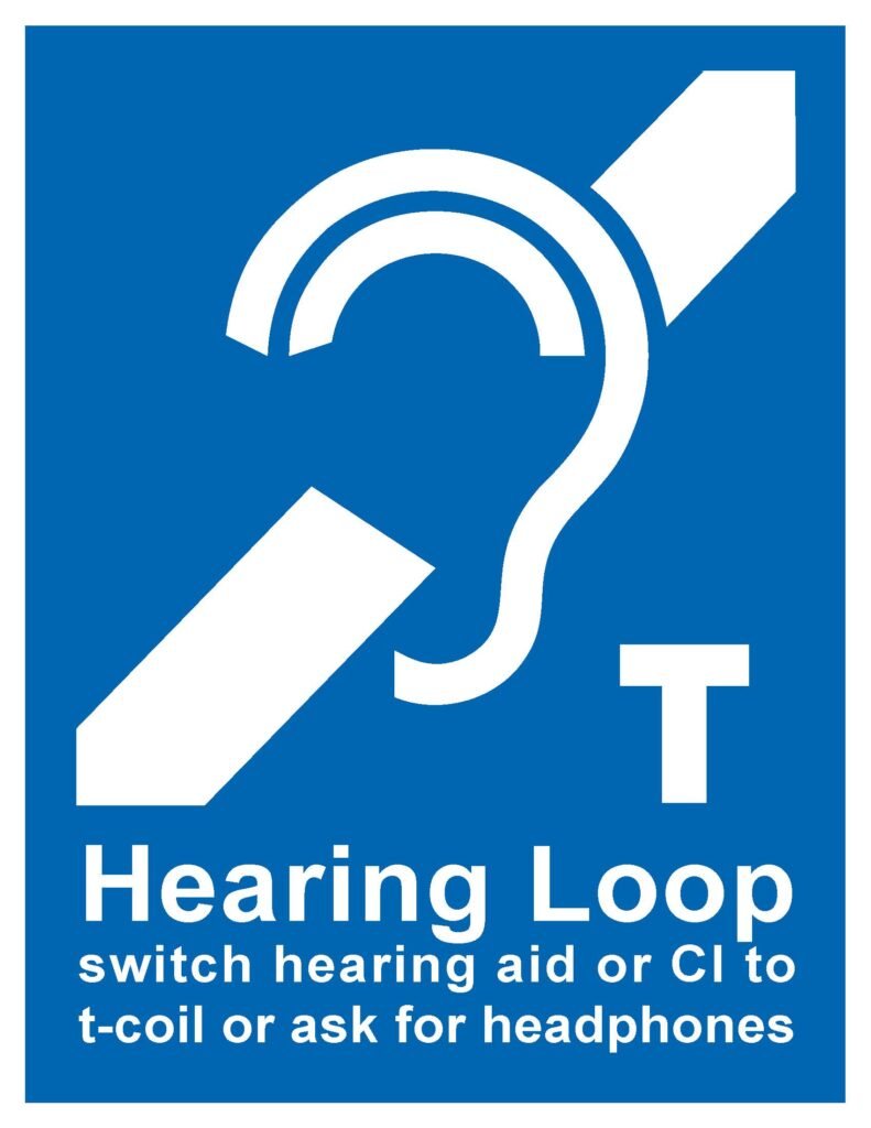 Blue sign. At top: International Symbol of Access for Hearing Loss. Bottom, white on blue background "switch hearing aid or CI to t-coil or ask for headphones"