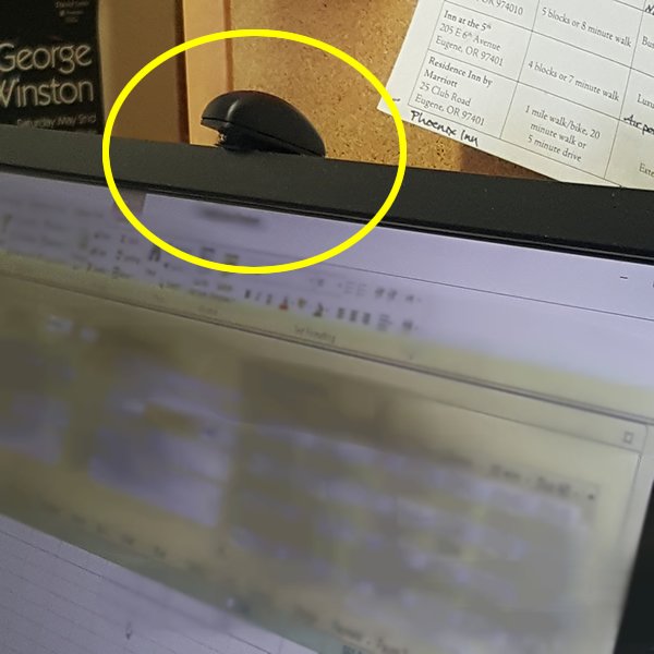 small microphone affixed to top of computer monitor